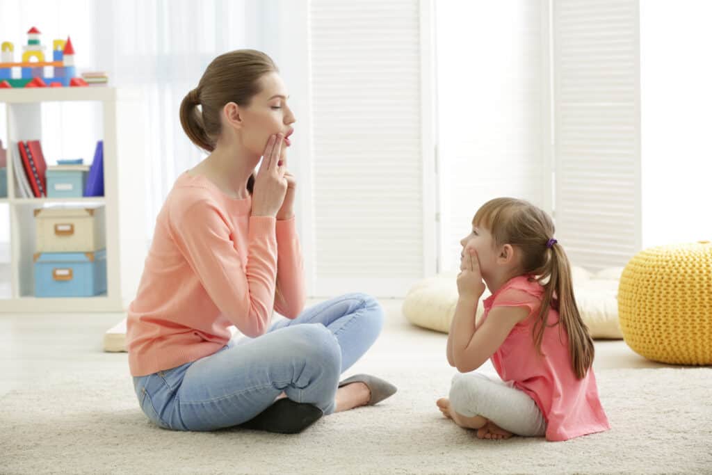 Child in articulation therapy session