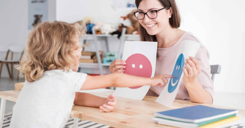A parent and a young child engaged in calm, attentive play on a warm, bright floor.
